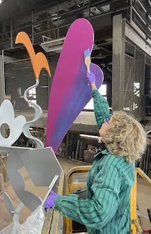 Ellen painting a sculpture